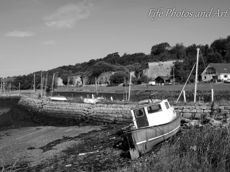 Old boat at Charlestown Harbour, Fife, with lime kilns in the background